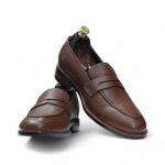 Styled Look: Man pairing brown loafers with a blazer and chinos for a sharp outfit.