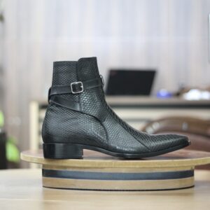 Side view of men’s black dress boots with a sleek buckle strap design