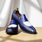 Close-up of men's handmade blue and white slip-on leather loafers.