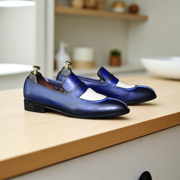 Men's handmade blue and white leather loafers with sleek stitched detailing.